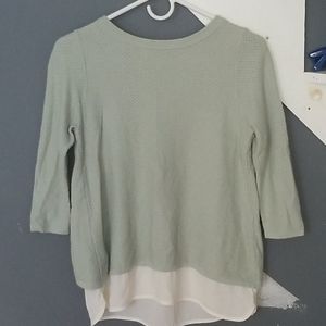 A greenish gray top with sheer white bottom